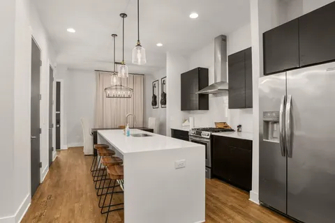 a kitchen with a sink stove and refrigerator