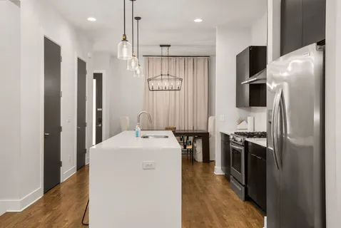 a kitchen with stainless steel appliances a sink dishwasher stove and refrigerator