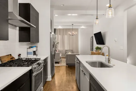 a living room with furniture and a chandelier