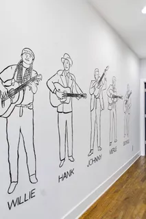 a bedroom with a bed couch and a potted plant