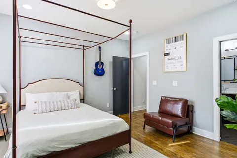 a bedroom with a bed and a potted plant