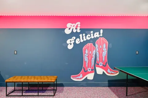 a living room with furniture kitchen view and a chandelier