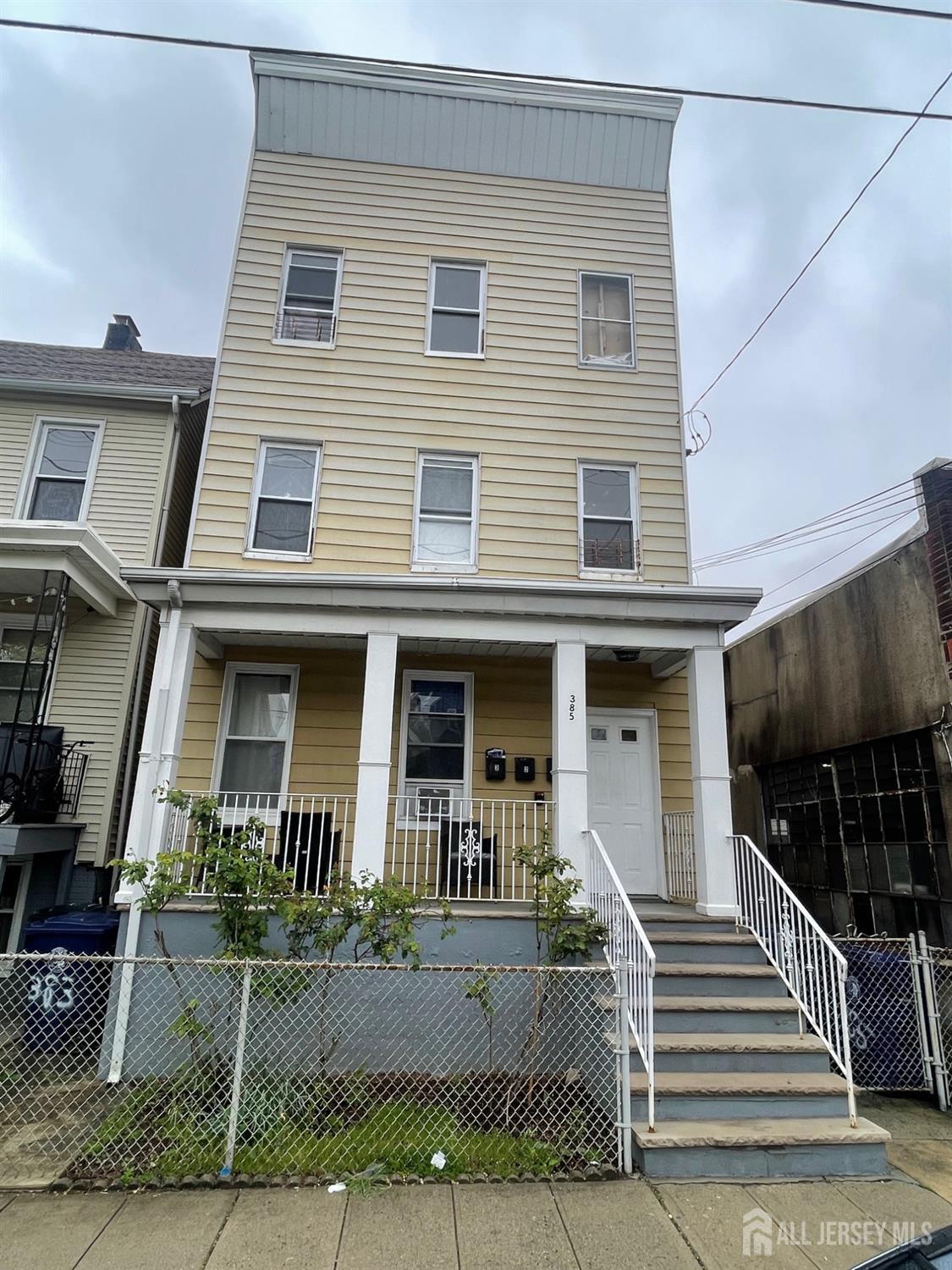 385 Washington Street Perth Amboy, NJ 08861 - Photo 1 of 13 a front view of a house
