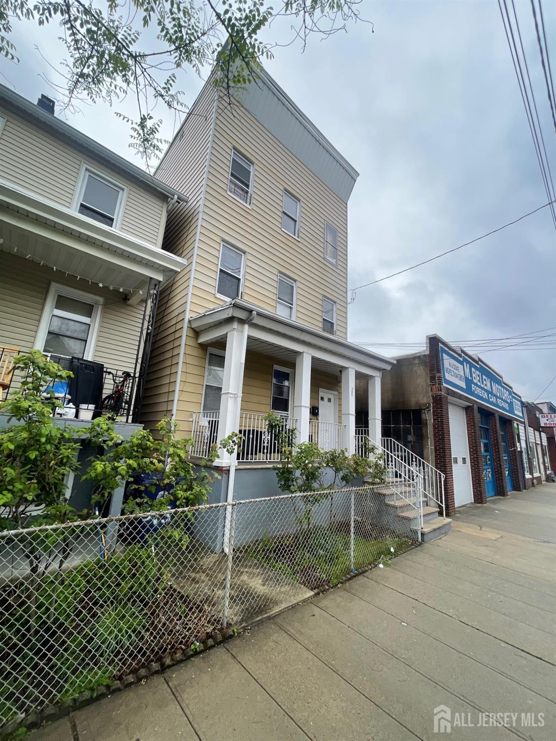 385 Washington Street Perth Amboy, NJ 08861 - Photo 4 of 13 a front view of a house with garden