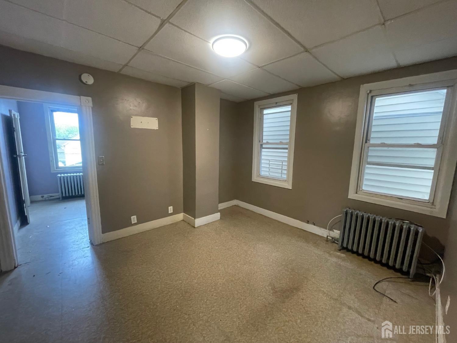 385 Washington Street Perth Amboy, NJ 08861 - Photo 7 of 13 an empty room with windows