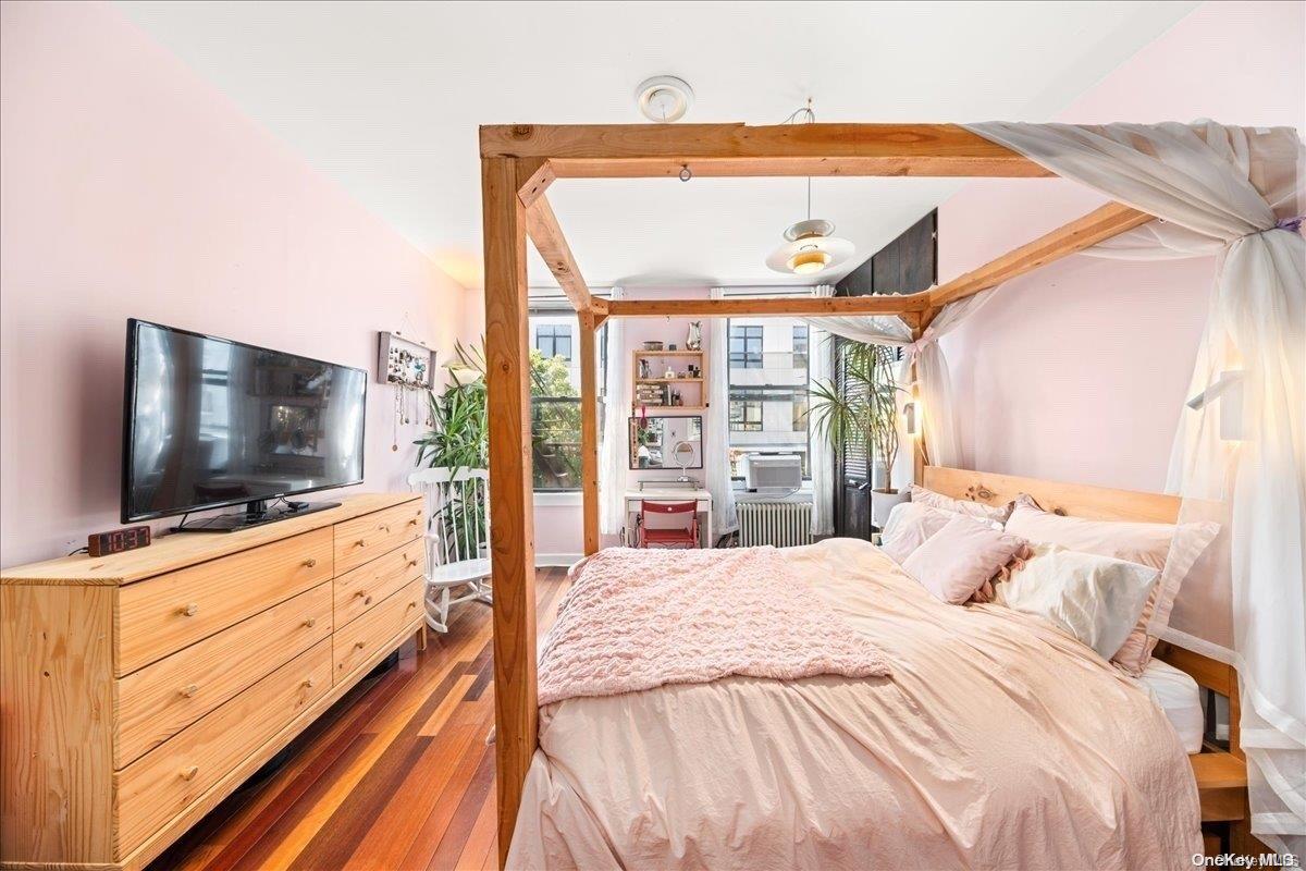 151 Eagle Street, Unit 3 Brooklyn, NY 11222 - Photo 9 of 11 a bedroom with a bed and a flat screen tv