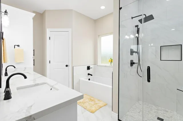 a bathroom with double vanity sinks and a mirror