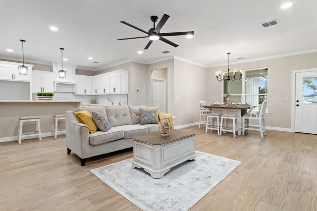 a living room with furniture and kitchen view