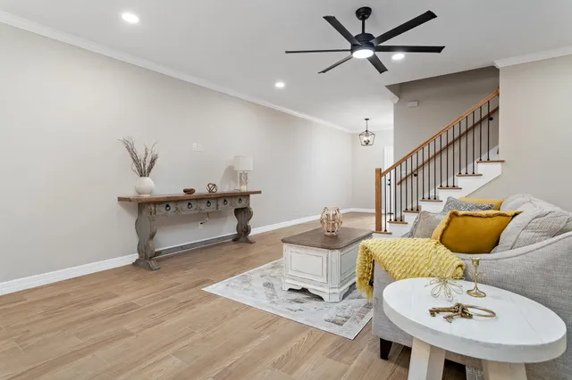 a living room with furniture and a wooden floor