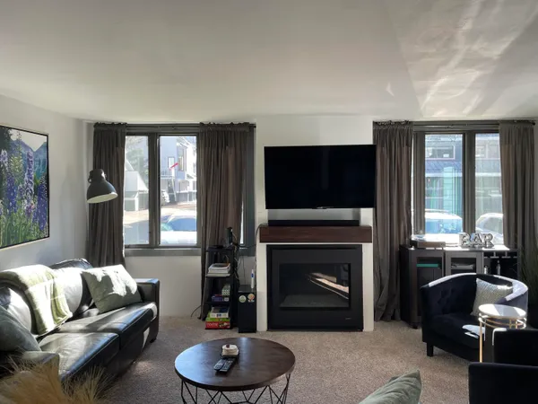 a kitchen with stainless steel appliances granite countertop a refrigerator a stove and a sink with wooden floor