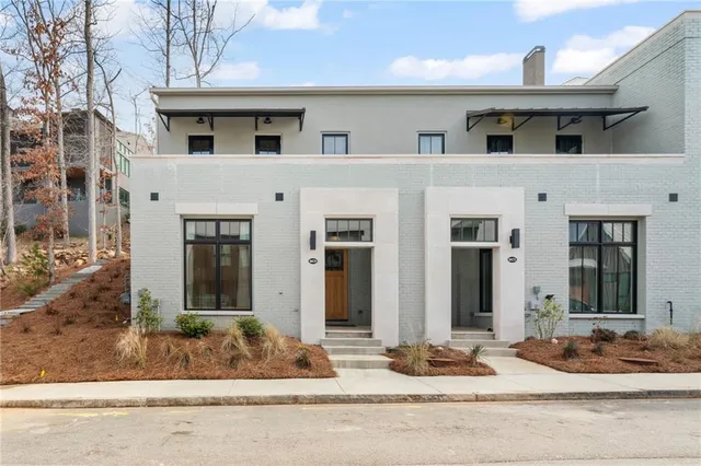 a front view of a house with sitting area