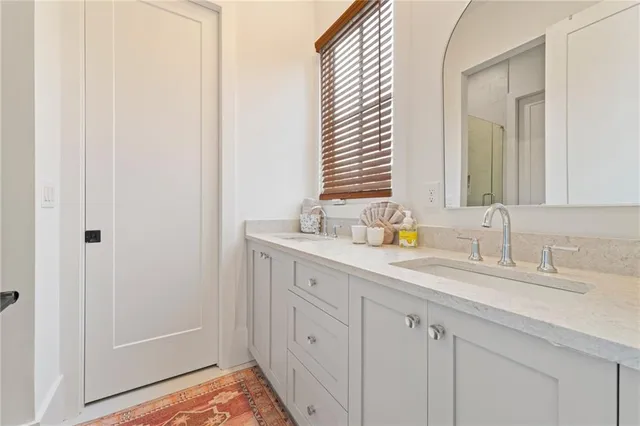 a bathroom with a double vanity sink and a mirror