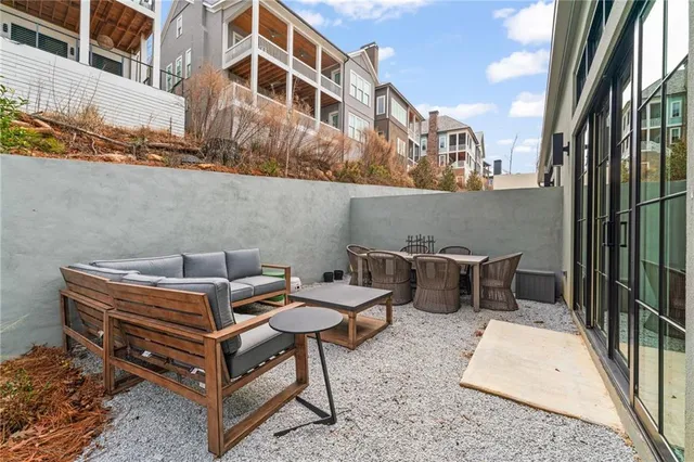 a backyard of a house with table and chairs