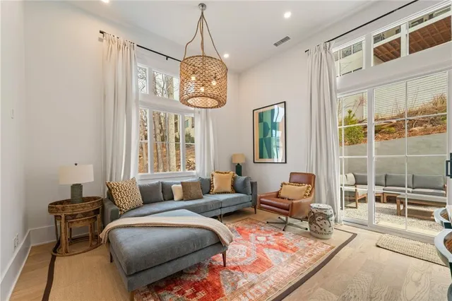 a living room with furniture chandelier and a window