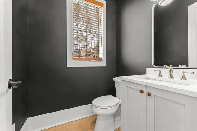 a bathroom with a sink a toilet and a mirror