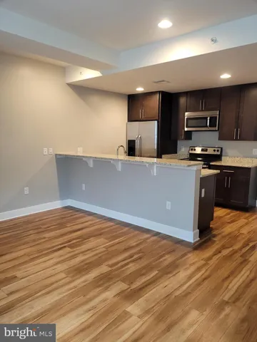 a kitchen with stainless steel appliances granite countertop a stove and a sink