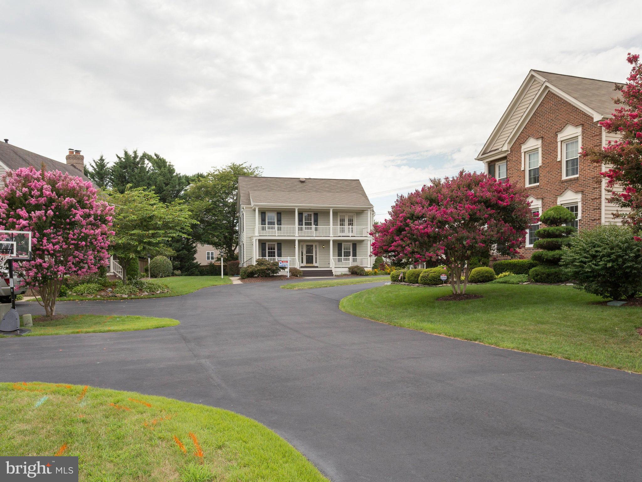 6564 Forsythia Street Springfield, VA 22150 - Photo 2 of 30 a front view of a house with garden