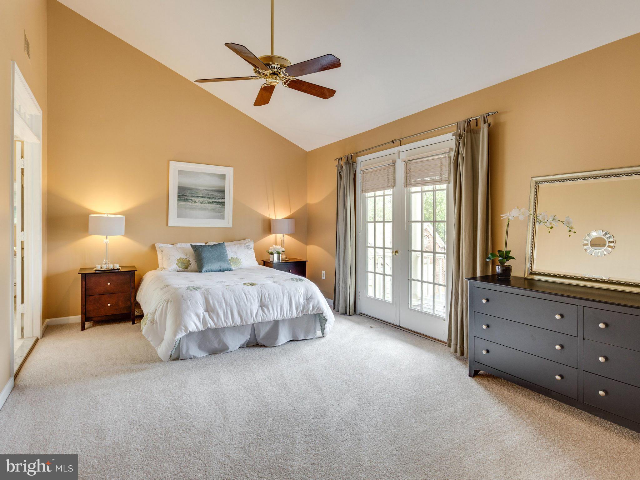 6564 Forsythia Street Springfield, VA 22150 - Photo 15 of 30 a spacious bedroom with a bed and a chandelier