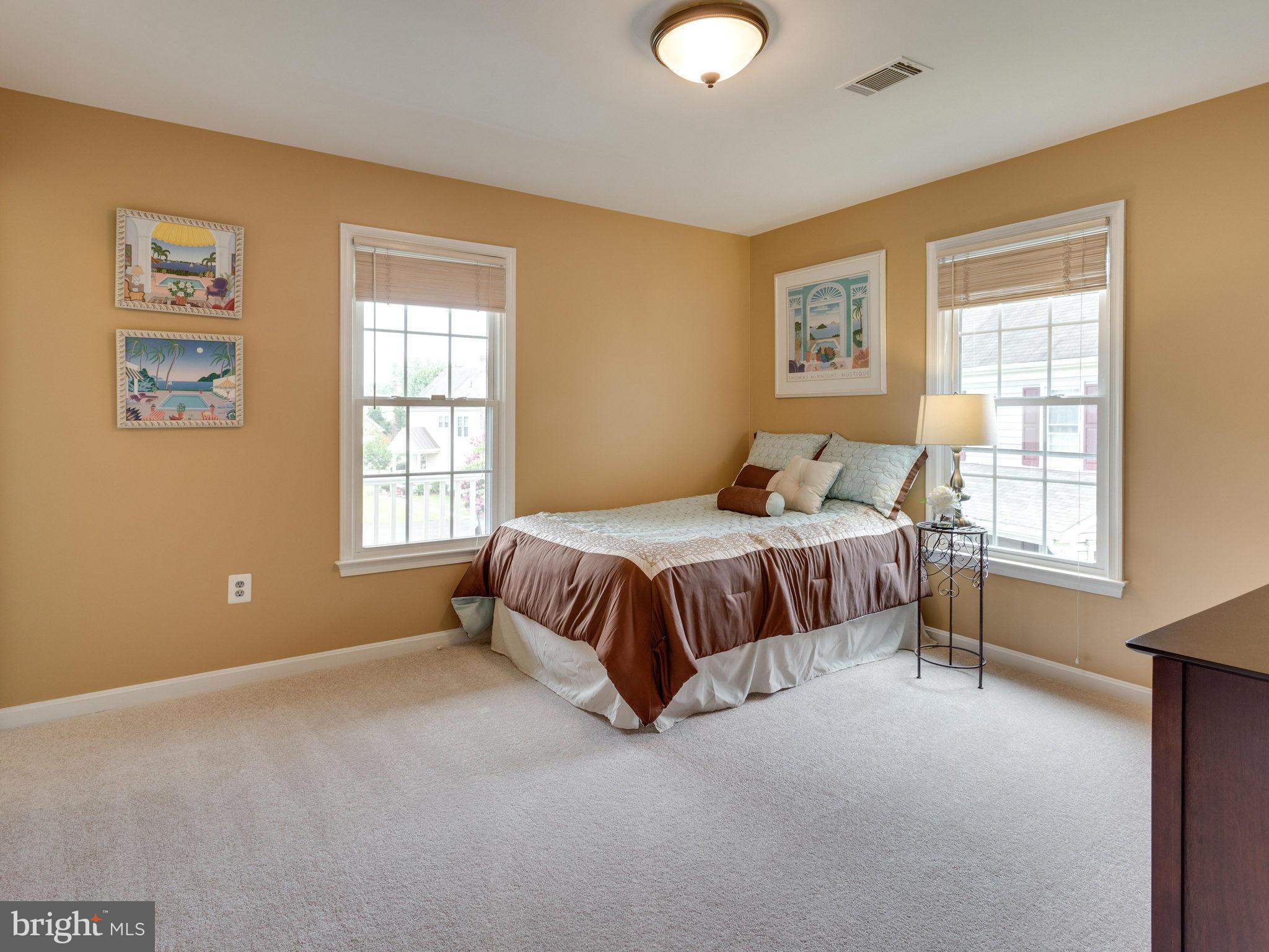 6564 Forsythia Street Springfield, VA 22150 - Photo 21 of 30 a bedroom with a bed lamp and with the window