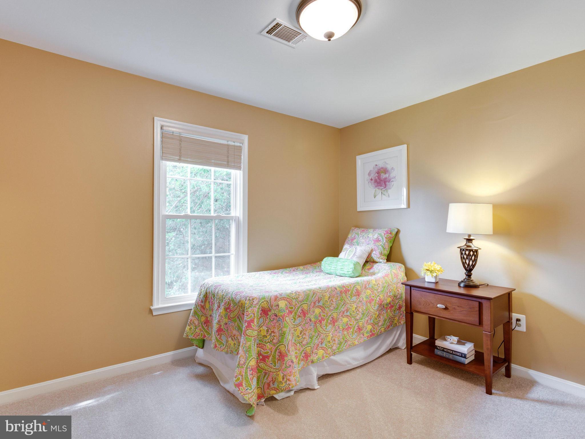 6564 Forsythia Street Springfield, VA 22150 - Photo 23 of 30 a bedroom with a bed and a window