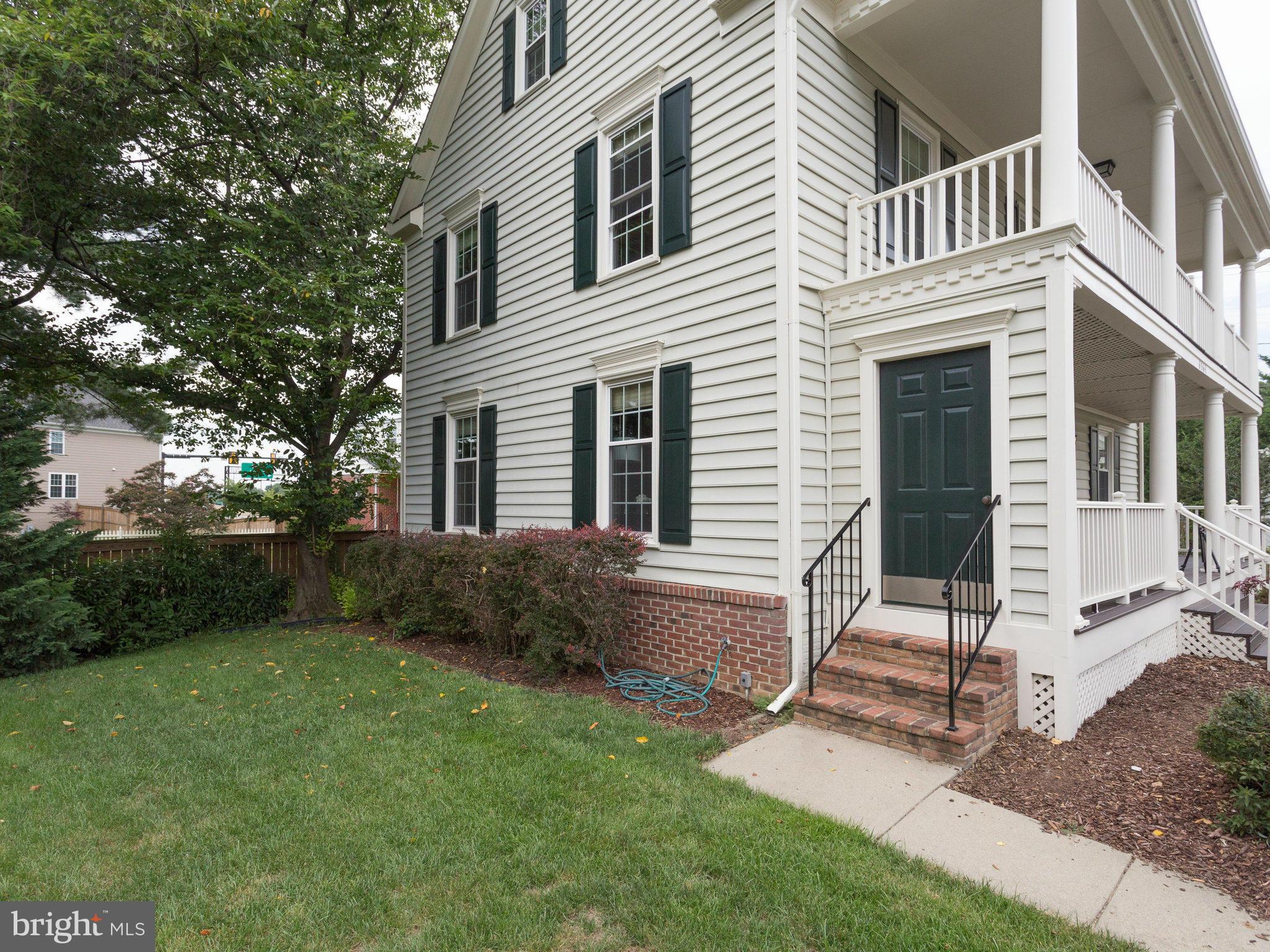 6564 Forsythia Street Springfield, VA 22150 - Photo 4 of 30 a view of backyard with a chair under a large tree