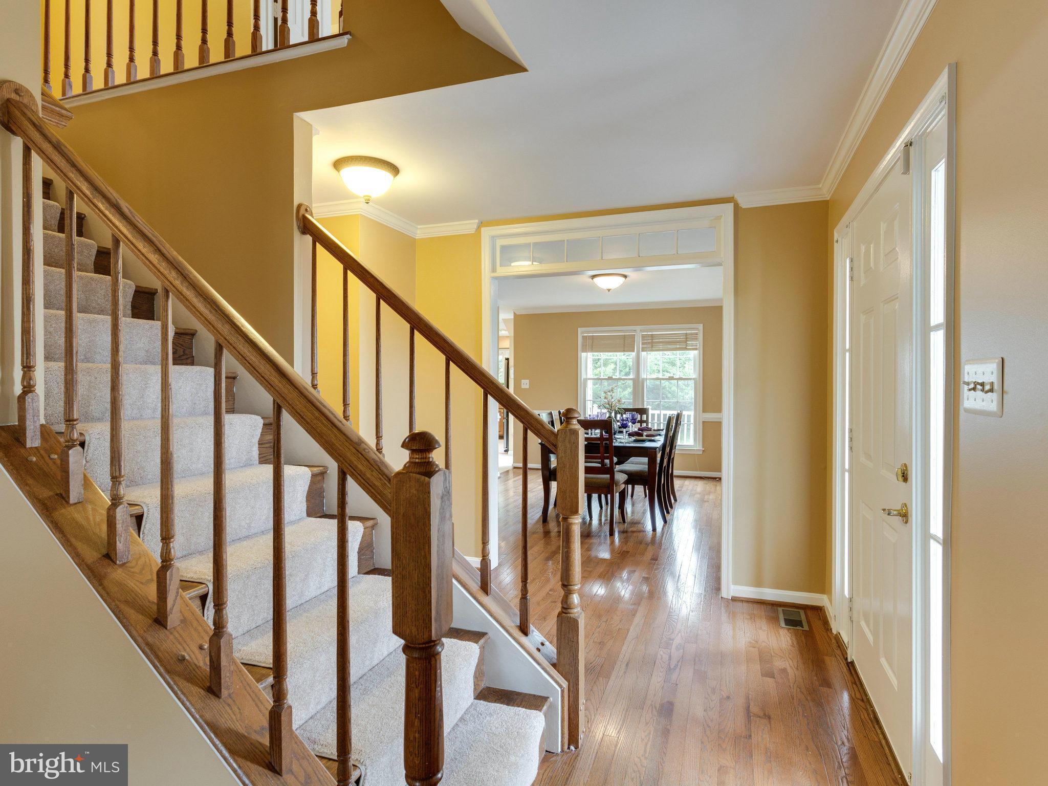 6564 Forsythia Street Springfield, VA 22150 - Photo 6 of 30 a view of dining room with wooden floor and stairs