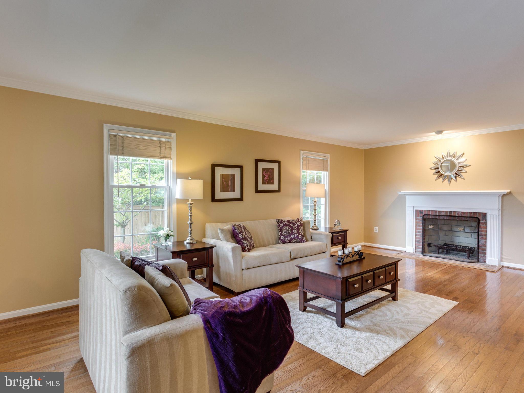 6564 Forsythia Street Springfield, VA 22150 - Photo 7 of 30 a living room with furniture and a fireplace