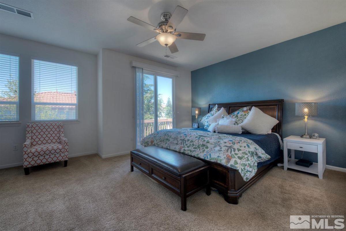 431 Shire Court Reno, NV 89521 - Photo 14 of 40 a spacious bedroom with a bed and a chandelier