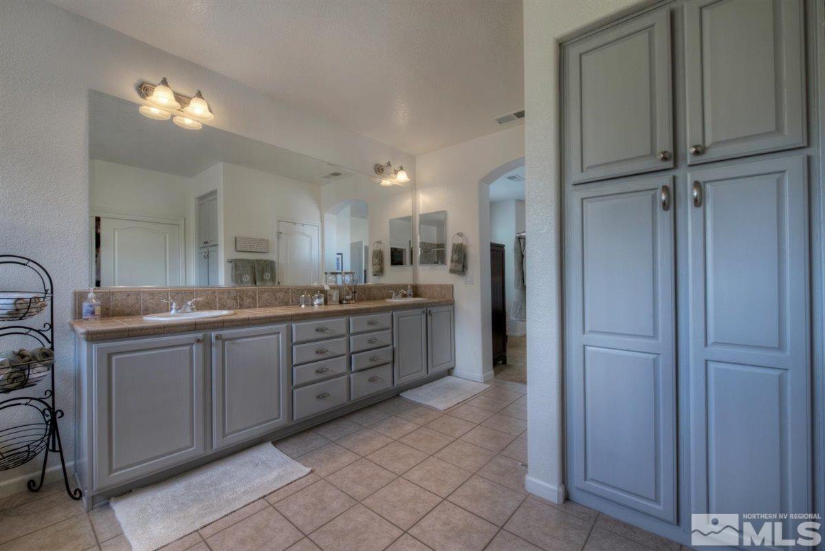 431 Shire Court Reno, NV 89521 - Photo 16 of 40 a large bathroom with a double vanity sink a and a shower