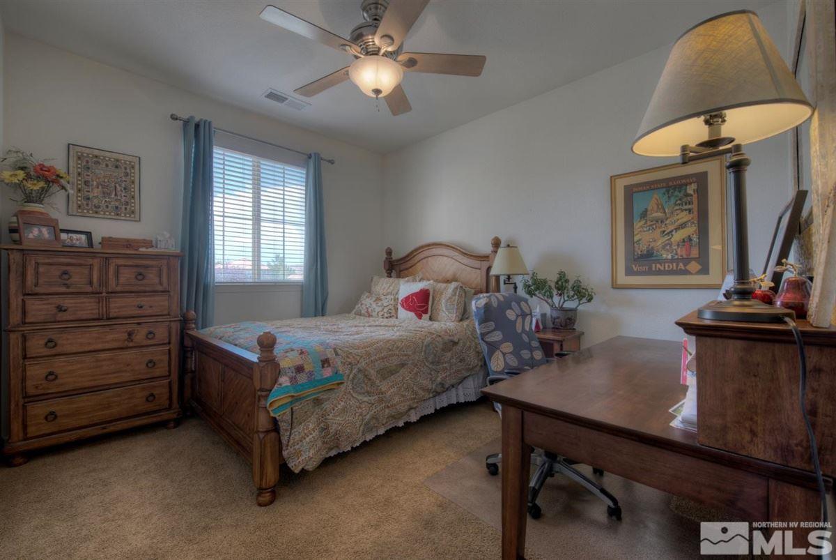 431 Shire Court Reno, NV 89521 - Photo 21 of 40 a bedroom with a bed and a table in it
