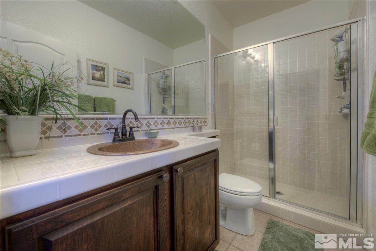 431 Shire Court Reno, NV 89521 - Photo 25 of 40 a bathroom with a sink a toilet and shower