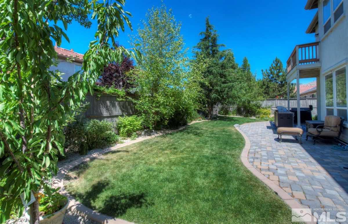 431 Shire Court Reno, NV 89521 - Photo 29 of 40 a view of a patio with table and chairs potted plants and large tree