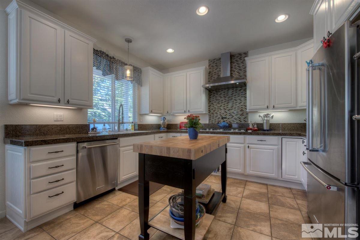 431 Shire Court Reno, NV 89521 - Photo 3 of 40 a kitchen with granite countertop a sink stove and refrigerator