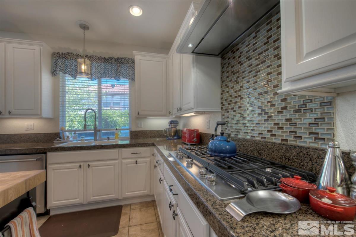 431 Shire Court Reno, NV 89521 - Photo 5 of 40 a kitchen with a stove a sink and cabinets