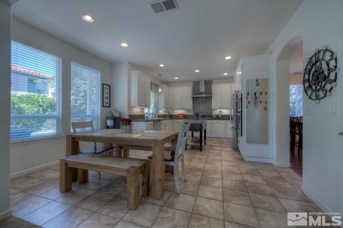 431 Shire Court Reno, NV 89521 - Photo 7 of 40 a kitchen with a dining table chairs and large window