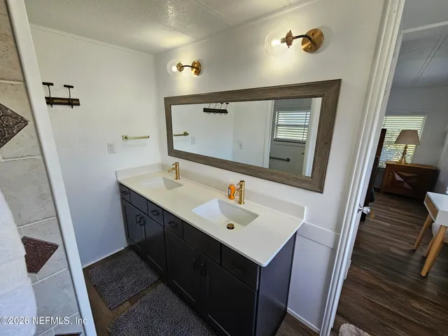 a view of walk in closet with clothes and shower