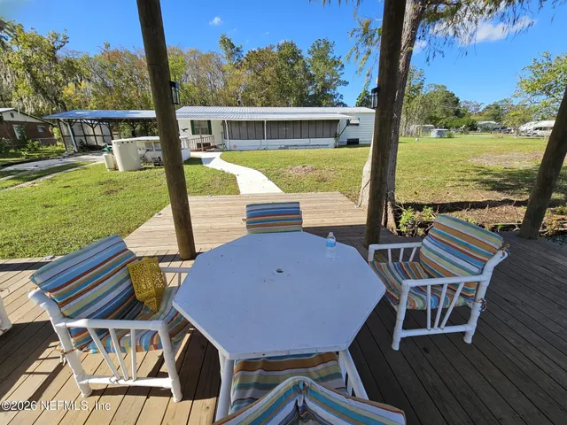 a large kitchen with a table chairs refrigerator and a sink