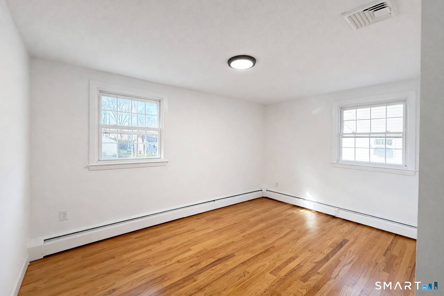 148 Hyde Road West Hartford, CT 06117 - Photo 14 of 24 an empty room with wooden floor and windows