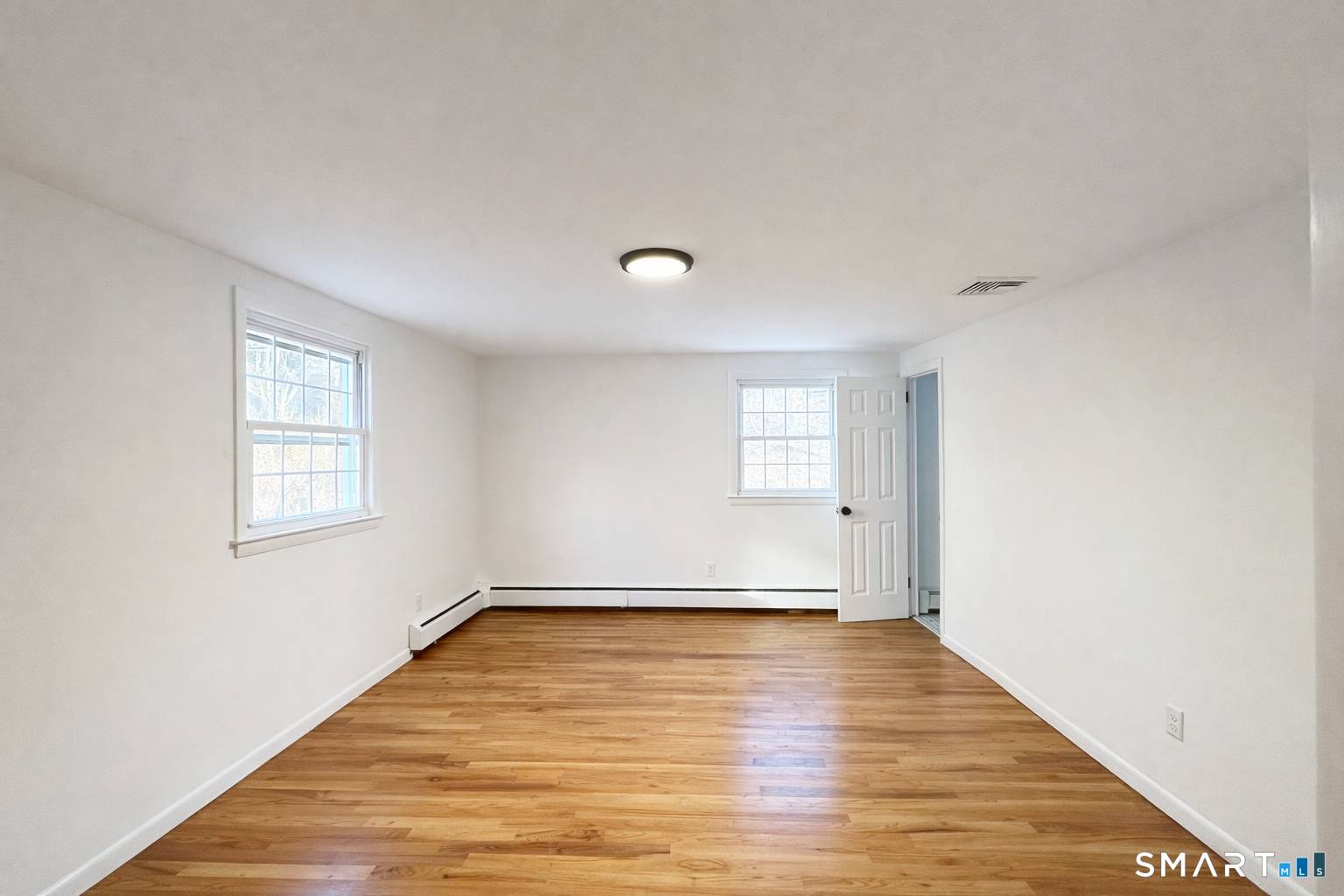 148 Hyde Road West Hartford, CT 06117 - Photo 15 of 24 a view of an empty room with wooden floor and a window