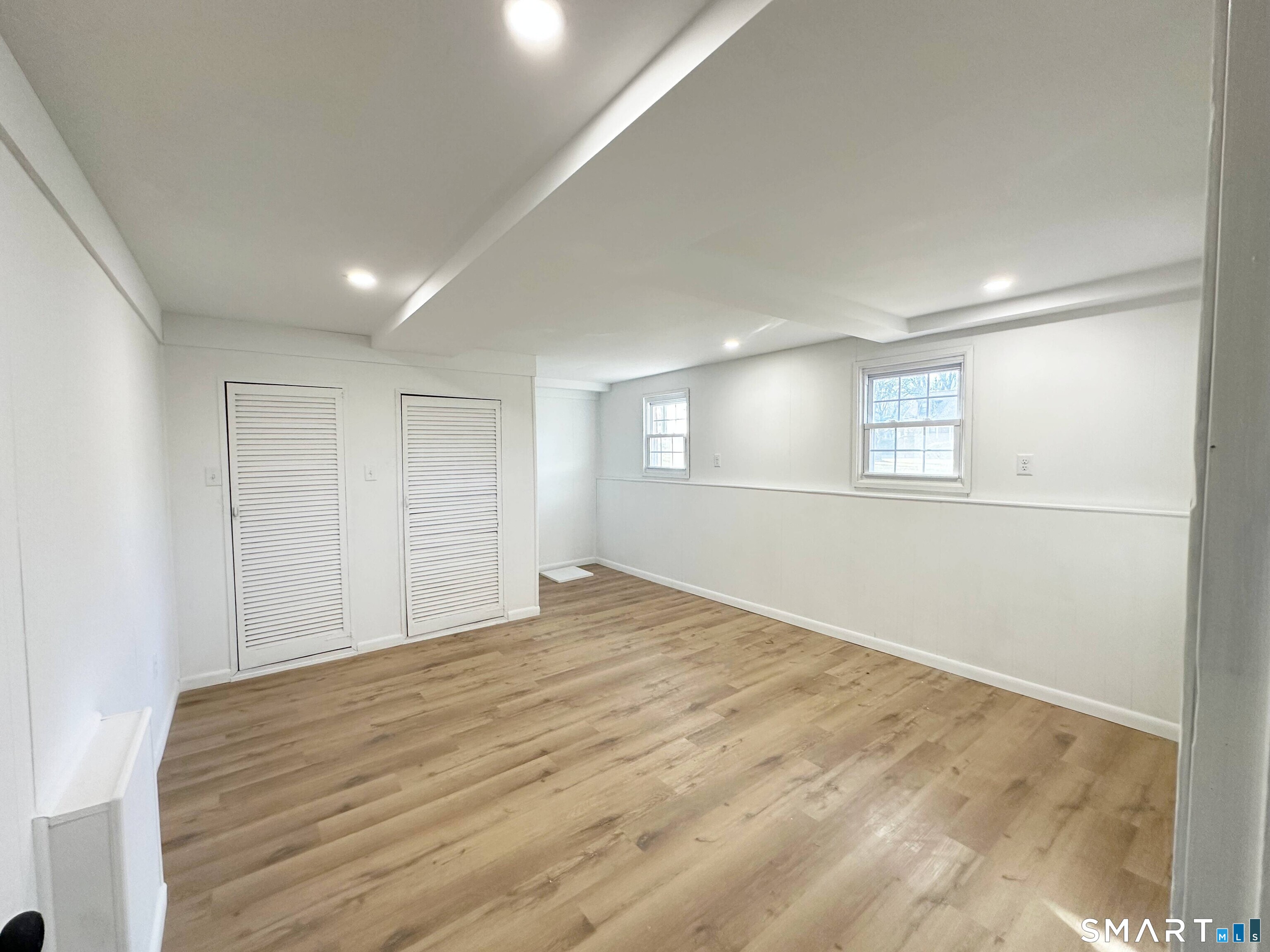 148 Hyde Road West Hartford, CT 06117 - Photo 23 of 24 a view of an empty room with wooden floor and a window