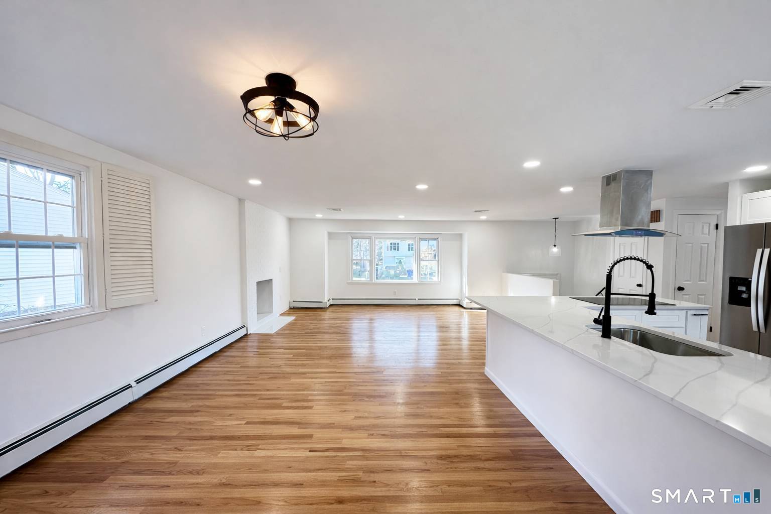 148 Hyde Road West Hartford, CT 06117 - Photo 5 of 24 a very nice looking room with wooden floor and a large window