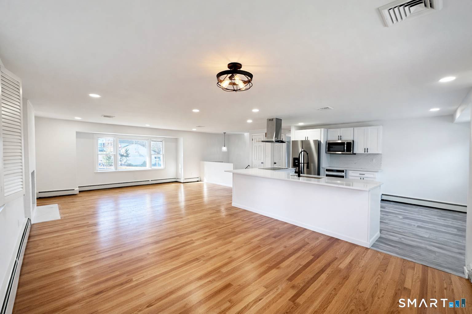 148 Hyde Road West Hartford, CT 06117 - Photo 6 of 24 a kitchen with stainless steel appliances cabinets a wooden floor and a sink