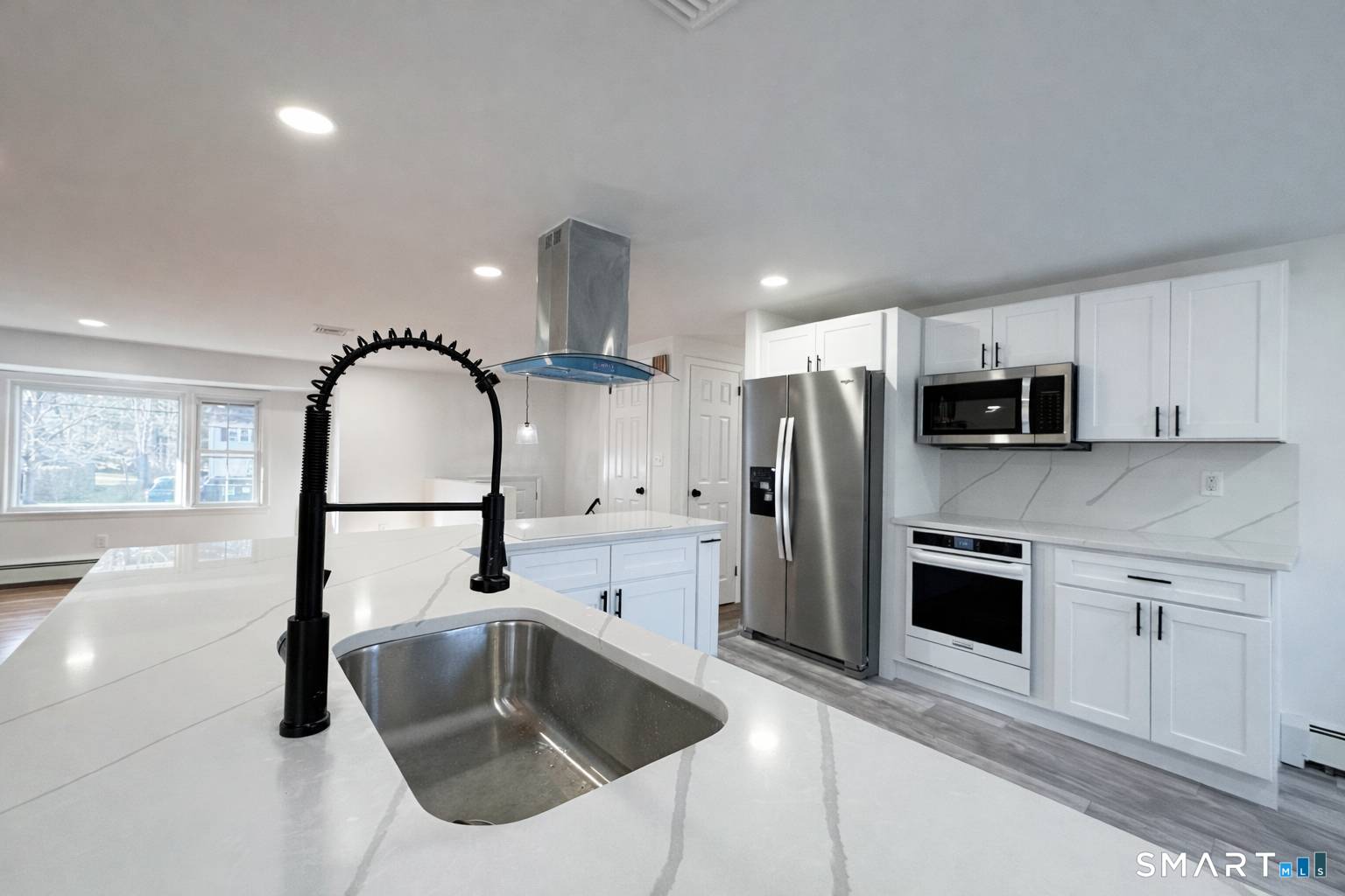 148 Hyde Road West Hartford, CT 06117 - Photo 9 of 24 a kitchen with stainless steel appliances a refrigerator sink and cabinets