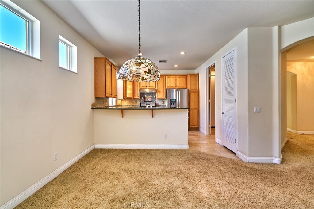 1143 Saguara Road Beaumont, CA 92223 - Photo 37 of 66 a view of a kitchen with a refrigerator and a dishwasher