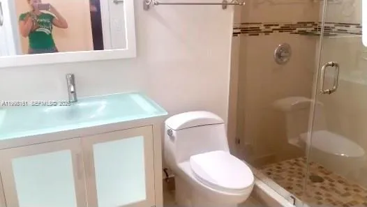 a white toilet sitting next to a bathroom sink