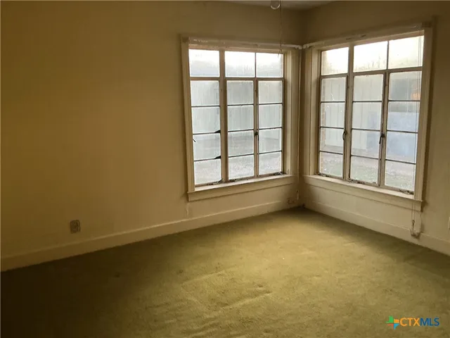 an empty room with a fireplace