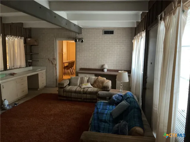 a living room with furniture and a window