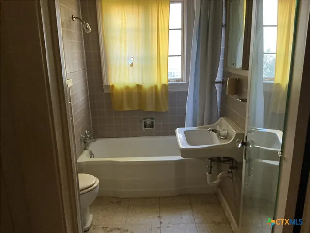 a bathroom with a sink a toilet and a bathtub