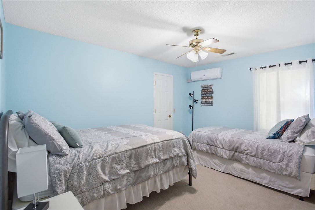110 Snug Harbor Road Seneca, SC 29678 - Photo 18 of 37 This spacious bedroom offers a tranquil retreat with soft blue walls and ample natural light.