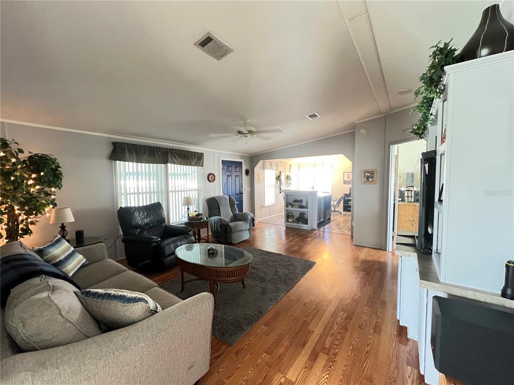 10100 Burnt Store Road, Unit 27 Punta Gorda, FL 33950 - Photo 11 of 37 a living room with furniture and a wooden floor